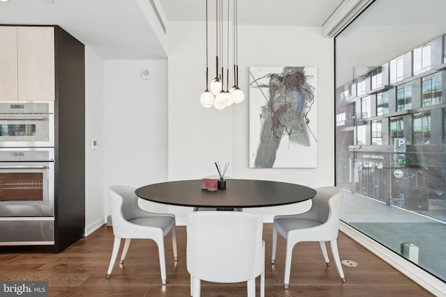 dining area featuring wood finished floors and baseboards