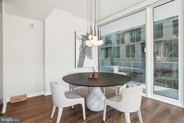 dining area featuring baseboards and wood finished floors