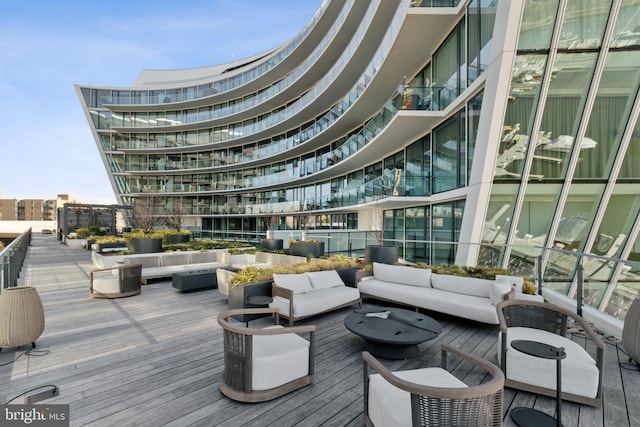 wooden terrace featuring a city view and an outdoor hangout area