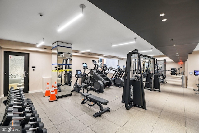 exercise room with recessed lighting and baseboards