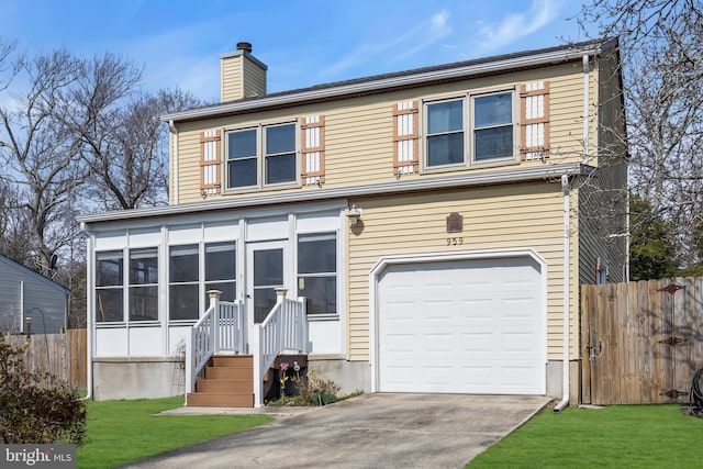 traditional-style house with a chimney, a sunroom, a garage, and fence