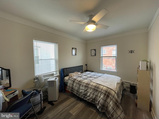 bedroom featuring ornamental molding, a baseboard heating unit, ceiling fan, and wood finished floors