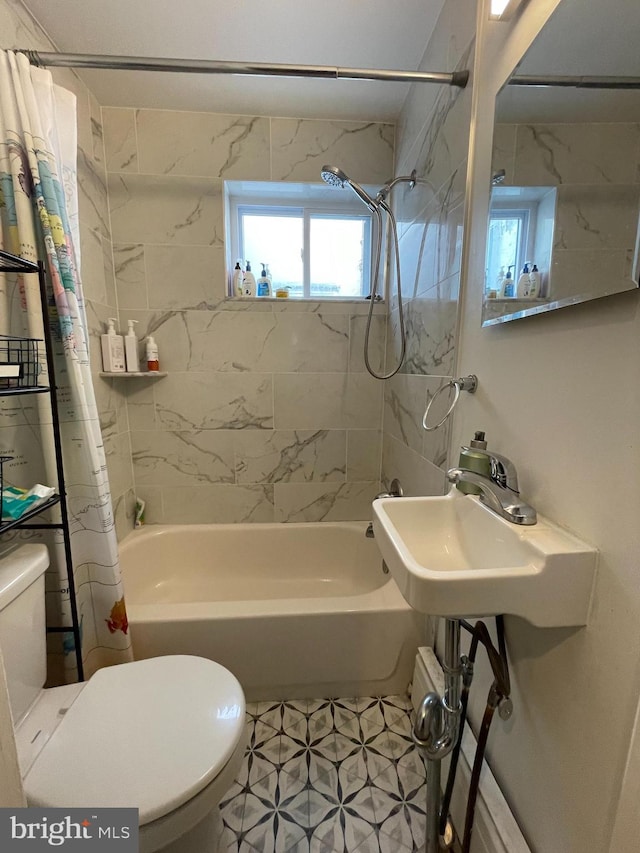 bathroom with toilet and shower / bath combo