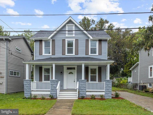 view of front of house featuring a porch, cooling unit, a front yard, and a shingled roof