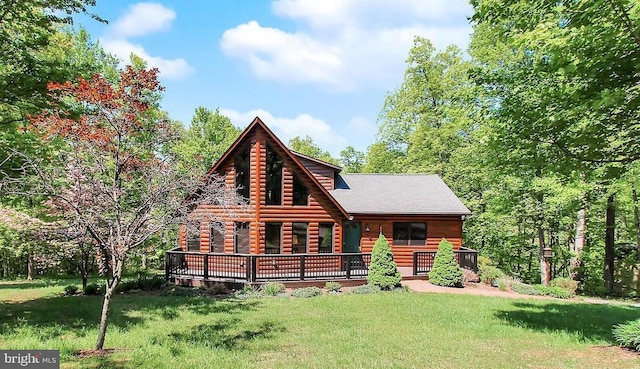 view of front of home with log exterior and a front yard