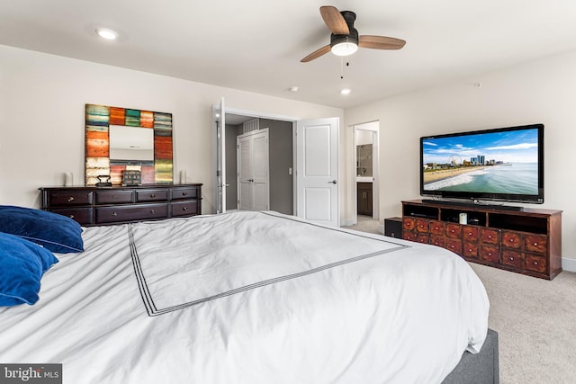 carpeted bedroom with recessed lighting, connected bathroom, and a ceiling fan