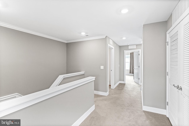 hallway featuring crown molding, baseboards, an upstairs landing, light carpet, and recessed lighting