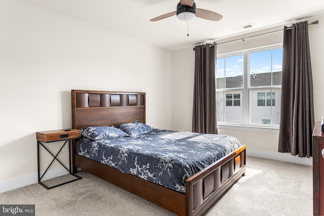 bedroom featuring visible vents, baseboards, carpet, and a ceiling fan