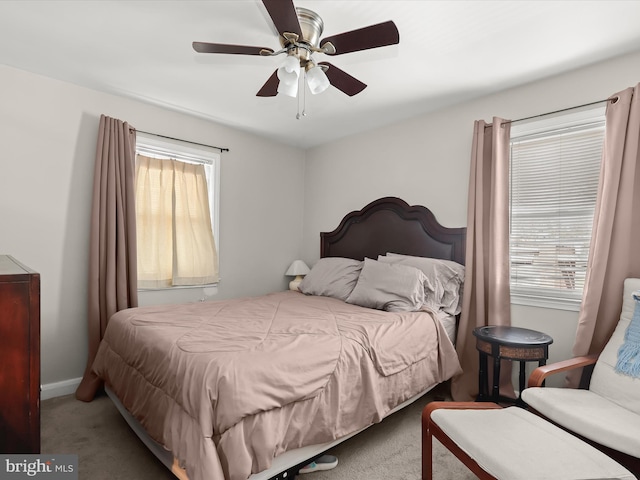 bedroom with ceiling fan, baseboards, and carpet