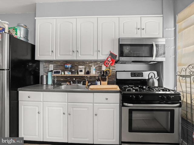 kitchen featuring white cabinets, appliances with stainless steel finishes, and a sink