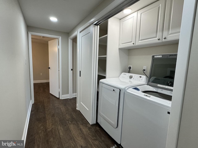 washroom featuring baseboards, cabinet space, dark wood-style flooring, and washer and clothes dryer