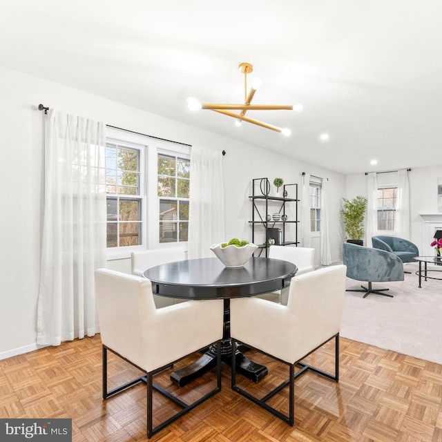 dining area featuring recessed lighting, a fireplace, baseboards, and an inviting chandelier