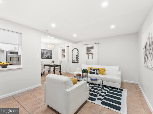 living room with light tile patterned floors, baseboards, and recessed lighting