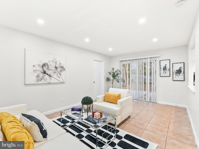 living room featuring light tile patterned flooring, recessed lighting, and baseboards