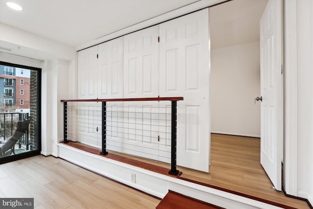 interior space with light wood-style flooring, recessed lighting, and baseboards