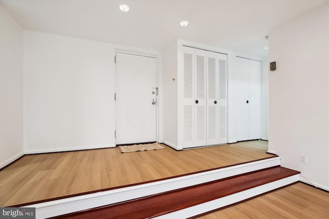 foyer featuring recessed lighting, wood finished floors, and baseboards