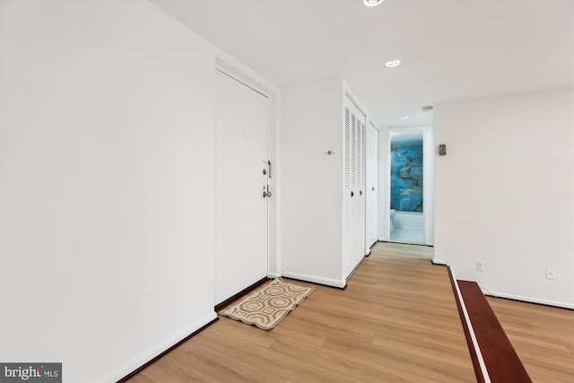 entryway featuring recessed lighting, baseboards, and light wood-style floors