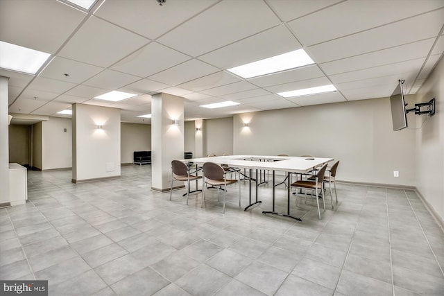 dining area with baseboards and a paneled ceiling