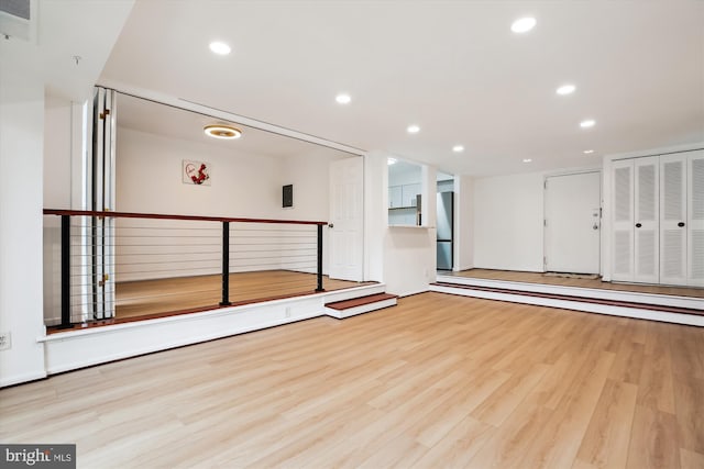 exercise area with visible vents, recessed lighting, and wood finished floors