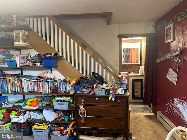 interior space with a baseboard radiator and carpet flooring