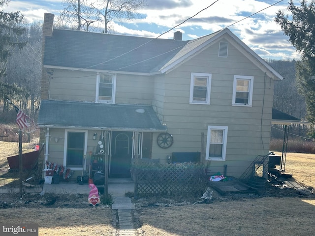 view of front of house with a porch and a chimney