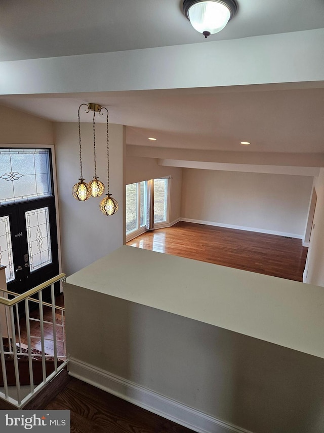 entryway featuring stairs, baseboards, and wood finished floors