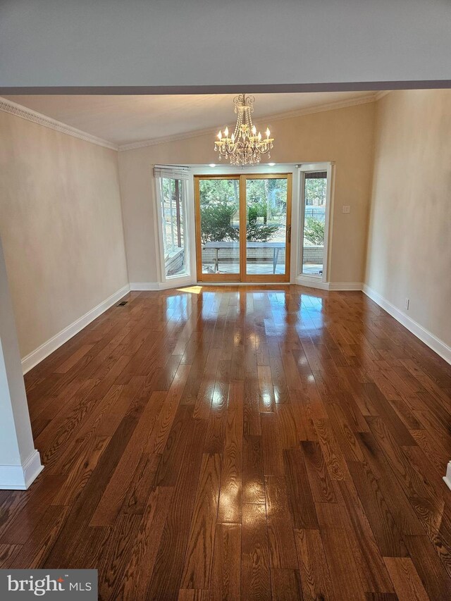 interior space featuring dark wood finished floors, a healthy amount of sunlight, crown molding, and baseboards