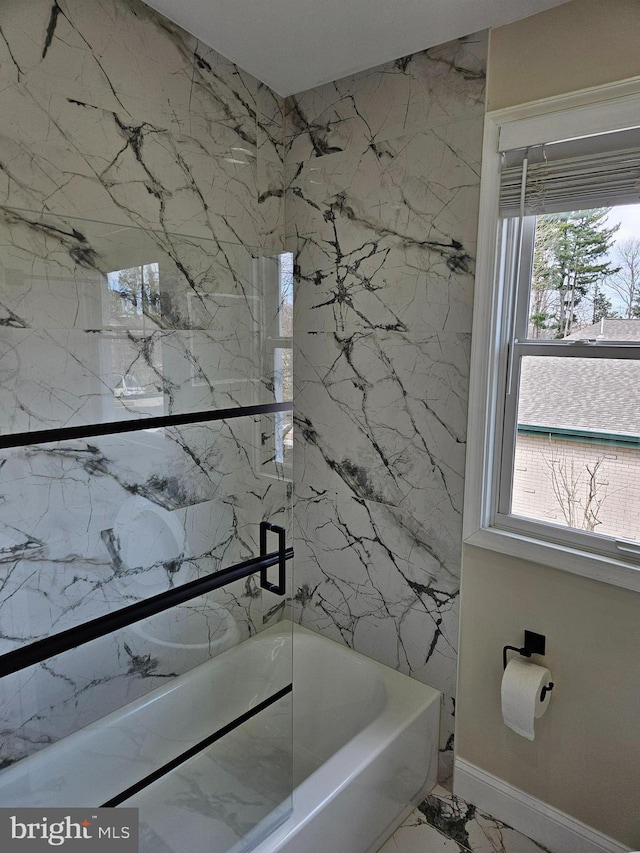 full bath with a wealth of natural light and marble finish floor