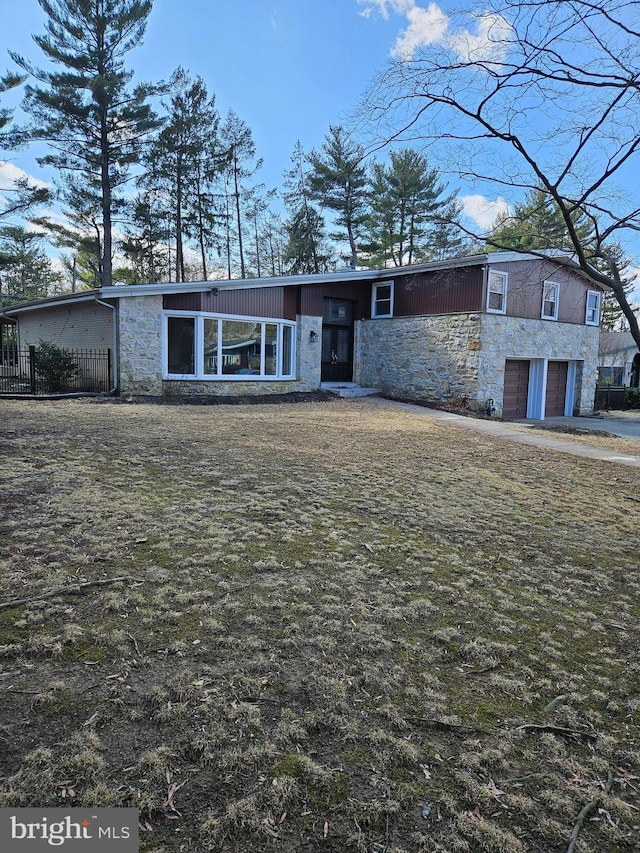 view of front of house with stone siding and a garage