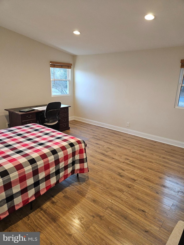 bedroom with recessed lighting, baseboards, and wood finished floors