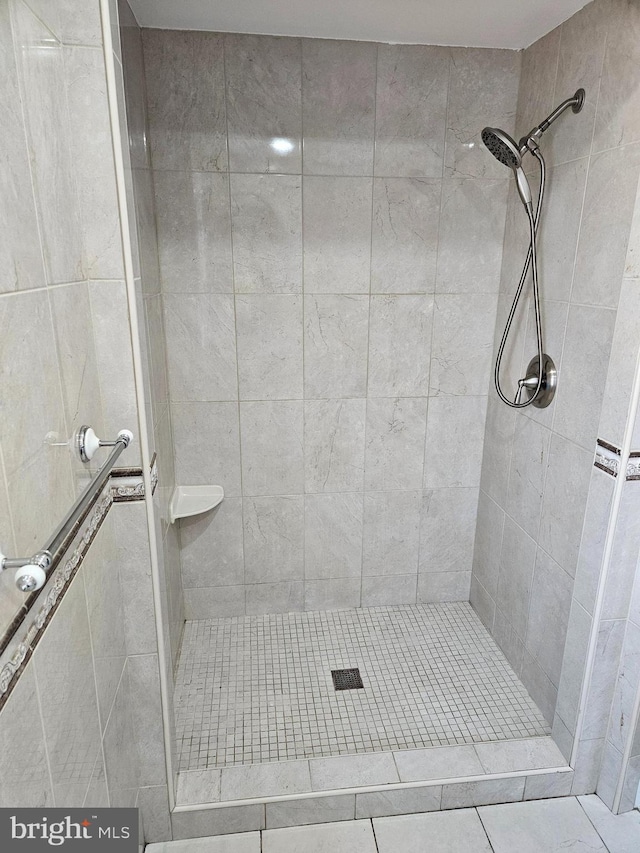 full bathroom with a tile shower