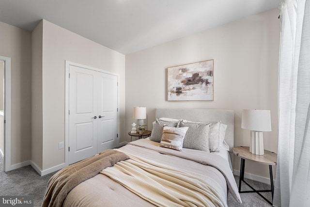 bedroom with baseboards, carpet floors, and a closet