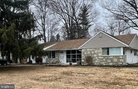 single story home with stone siding