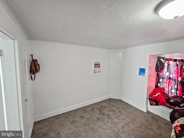 empty room with baseboards and carpet