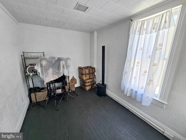 office area with hardwood / wood-style flooring, crown molding, plenty of natural light, and a textured wall