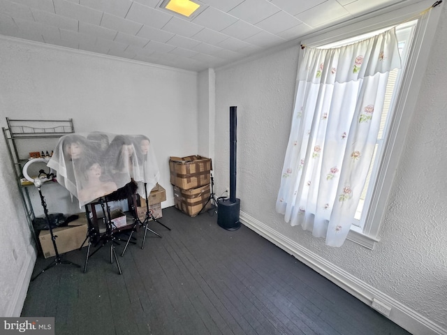 office area with hardwood / wood-style floors, a textured wall, and ornamental molding