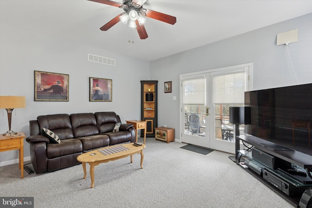 carpeted living area featuring visible vents, ceiling fan, french doors, and baseboards