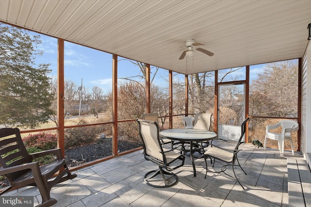 unfurnished sunroom with a ceiling fan and a healthy amount of sunlight