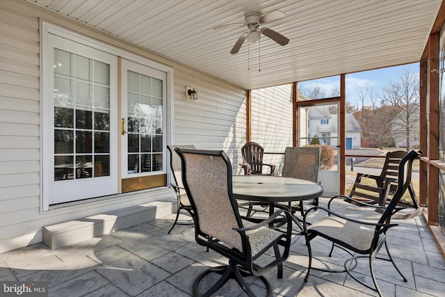 sunroom featuring wood ceiling and ceiling fan