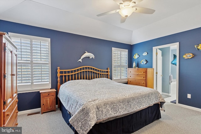 bedroom with visible vents, baseboards, carpet, and vaulted ceiling