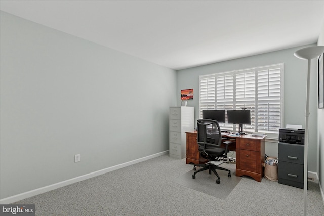 office area with baseboards and light carpet