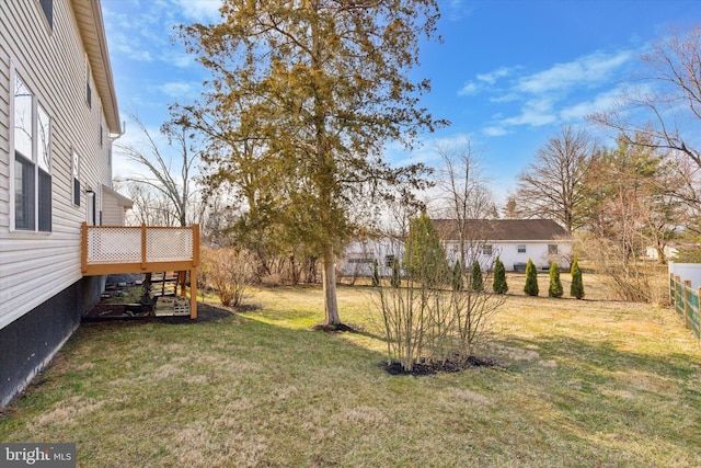 view of yard with a wooden deck and fence