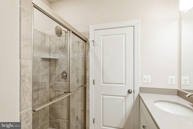 full bathroom with a stall shower and vanity