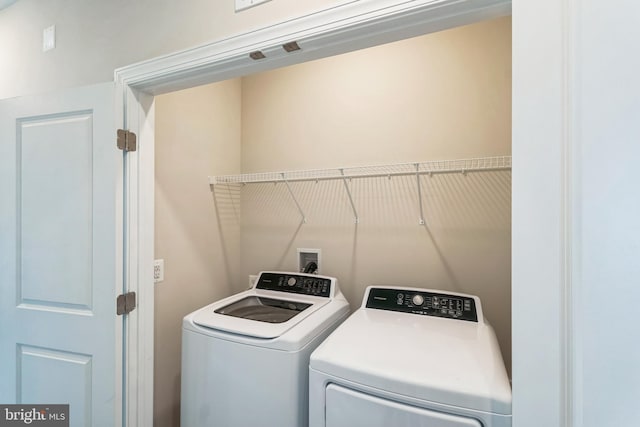 laundry area featuring washing machine and dryer and laundry area