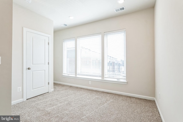 unfurnished bedroom featuring baseboards, visible vents, and carpet floors