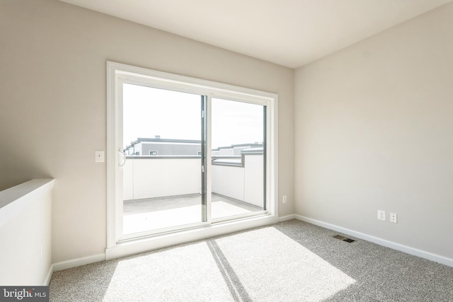 empty room with visible vents, baseboards, and carpet flooring