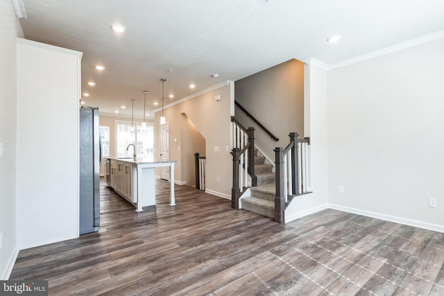 unfurnished living room featuring recessed lighting, dark wood finished floors, stairs, and ornamental molding