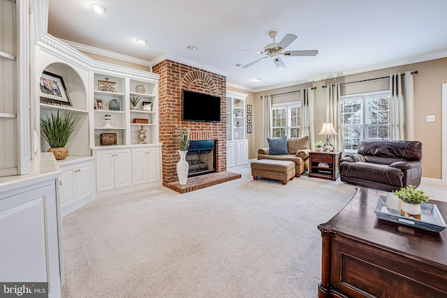 carpeted living room with built in features, ceiling fan, a fireplace, and crown molding