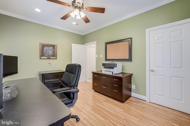 office space featuring light wood-type flooring, baseboards, ornamental molding, and a ceiling fan