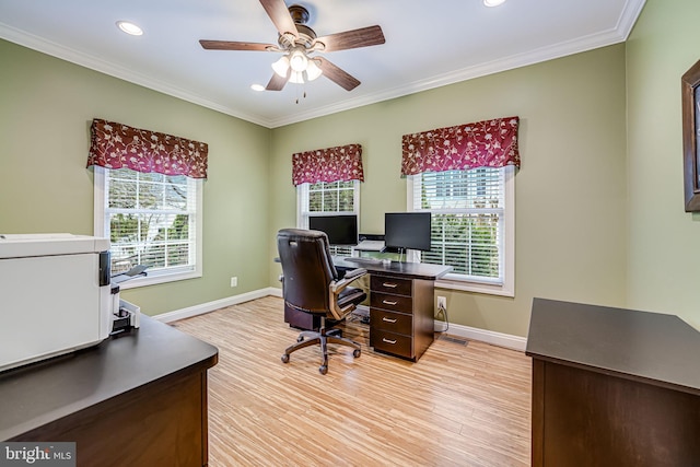 office area with light wood-style floors, a wealth of natural light, and ornamental molding